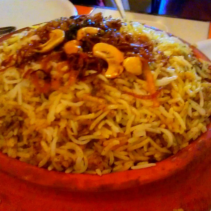 Dum biryani with cashews served in a clay pot